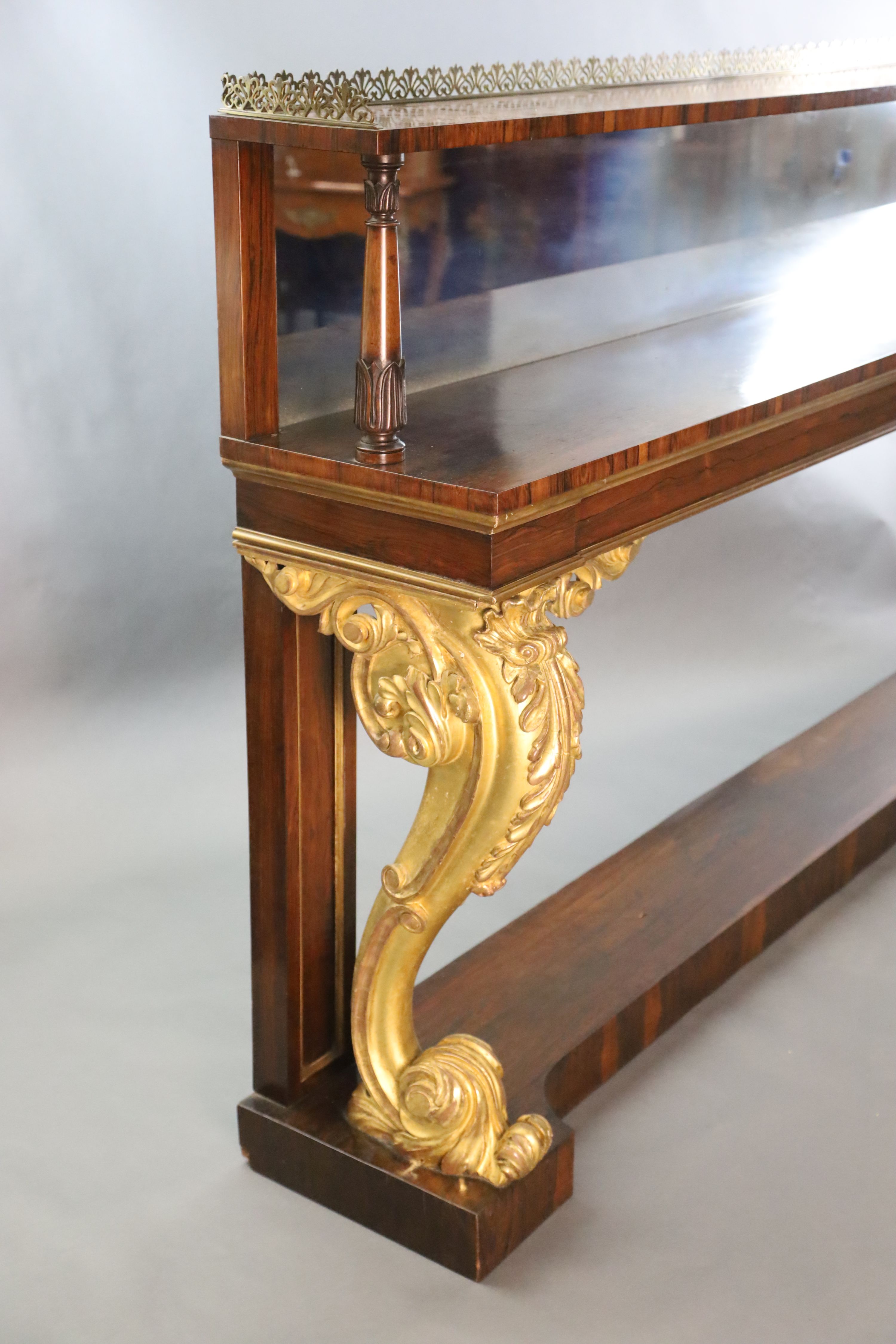 A pair of William IV parcel gilt rosewood console tables, W.8ft 2in. D.1ft 4in. H.4ft 4in.